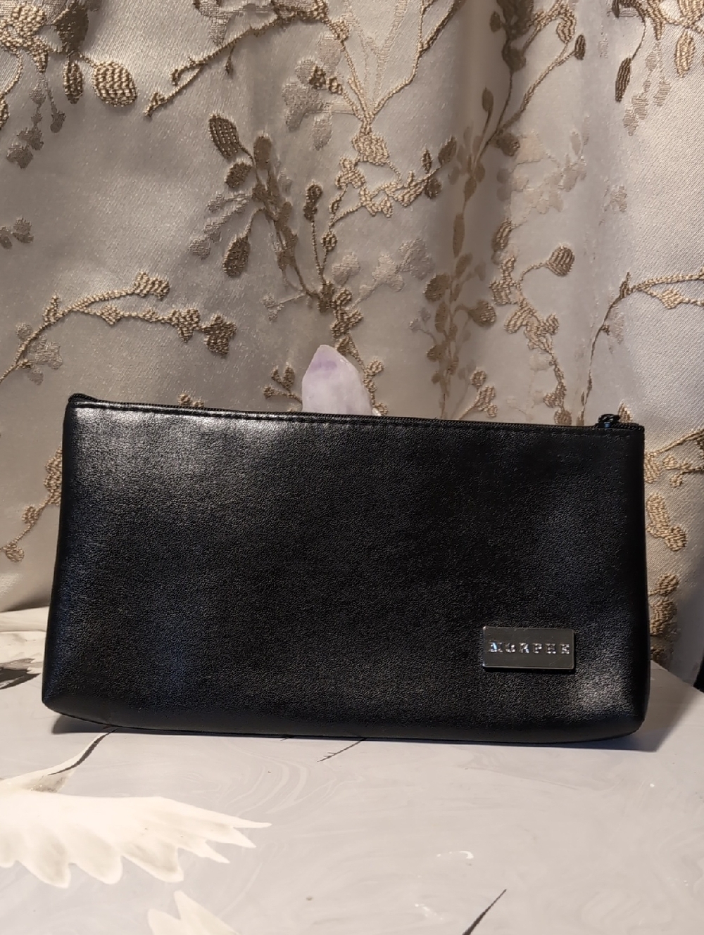 This is a black Morphe makeup brush bag.